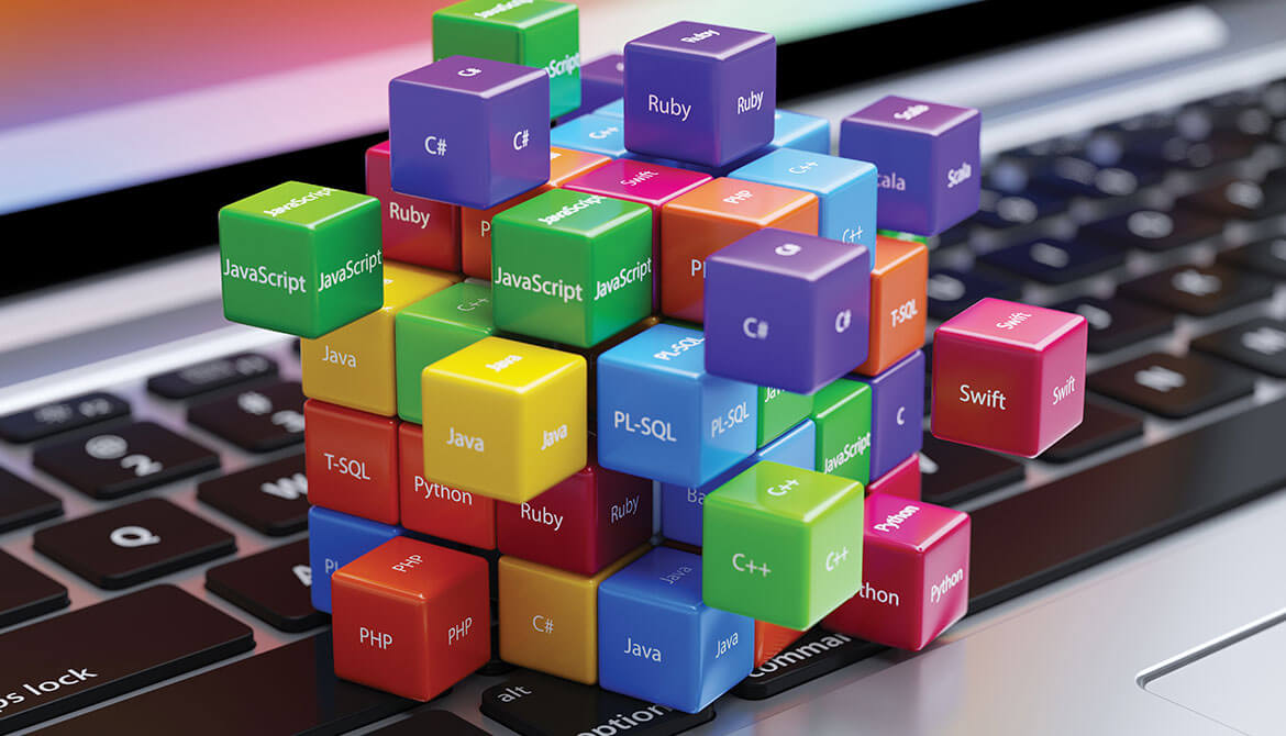 colorful blocks and cubes labeled with technology and programming language names connected together on top of laptop keyboard