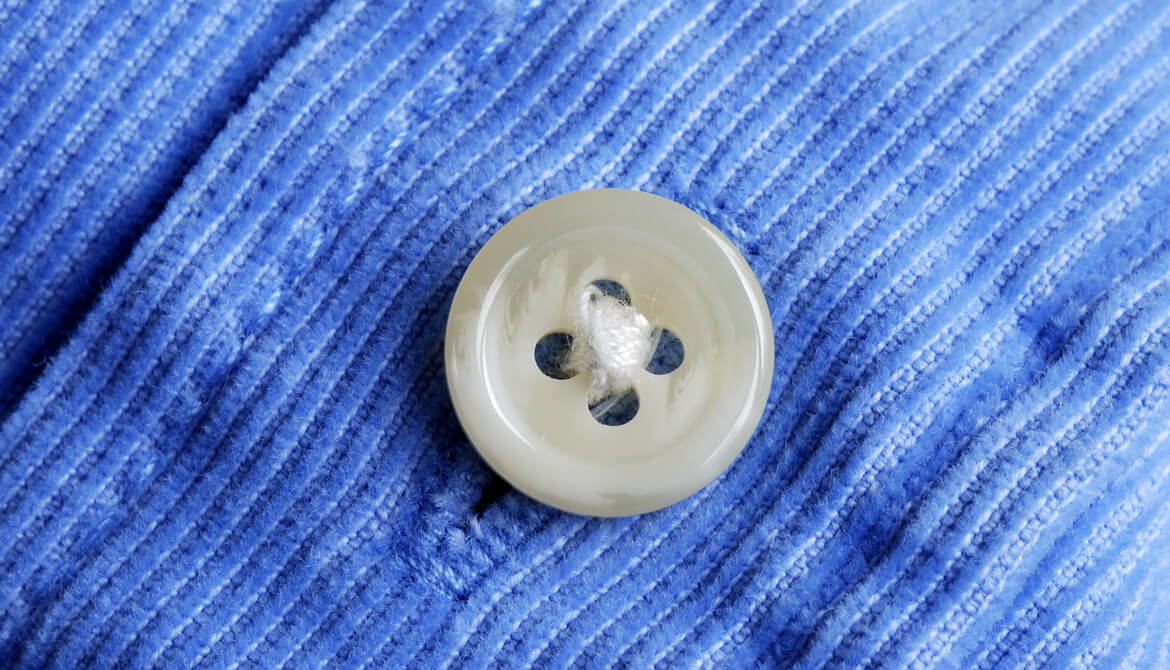 blue button on a blue shirt