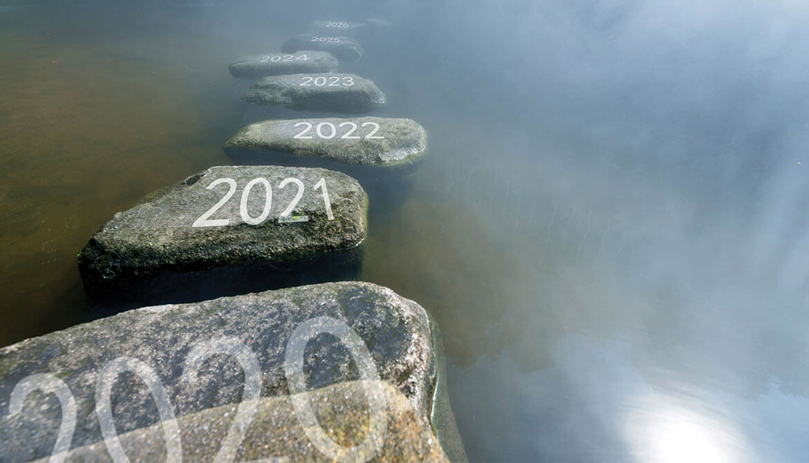 stepping stones labeled with 2021 and subsequent years crossing a misty river