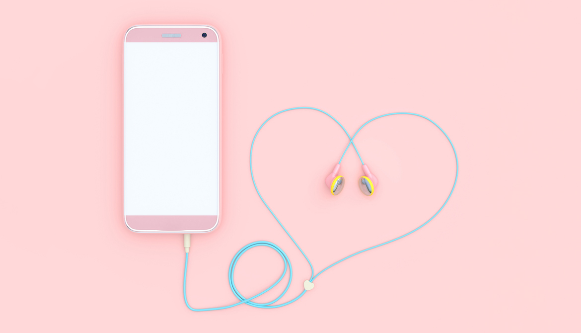 pink smartphone with earbud headphone cord curled into a heart shape