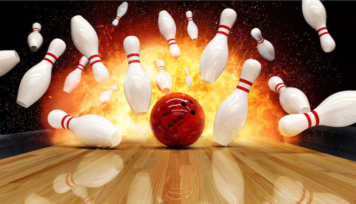 bowling ball makes impact with pins for a strike