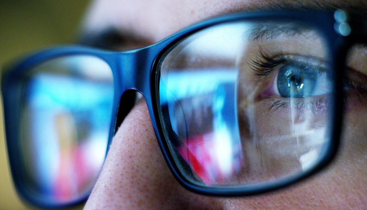 worker with reflection of the future in glasses