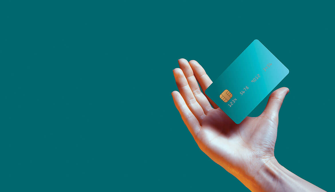 hand holding out floating teal credit card