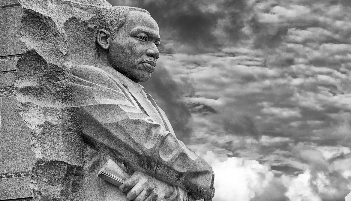 Martin Luther King Jr. memorial statue against cloudy sky