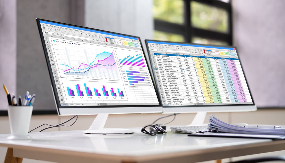 data analyst spreadsheet on two monitors