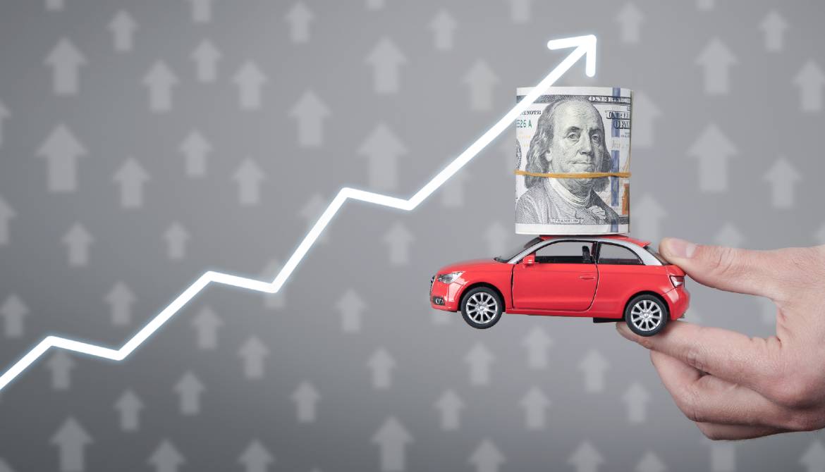 holding car with money and graph