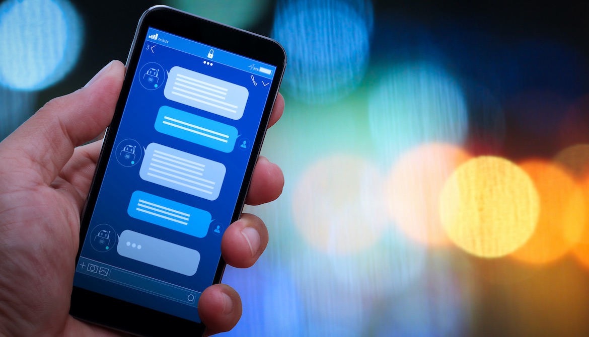 hand holding out phone displaying text message conversation with agent