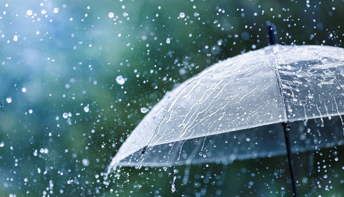 transparent umbrella splattered by heavy rain drops