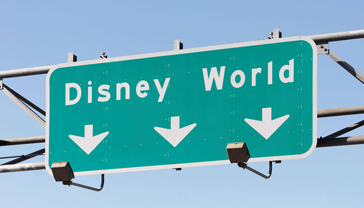 highway road sign pointing way to Disney world