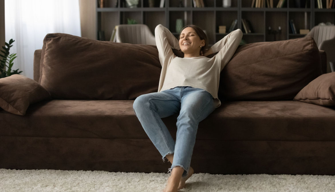 woman reclines on comfortable couch