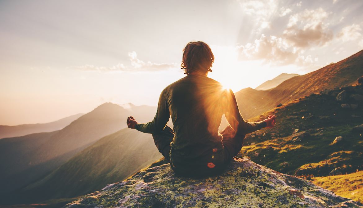 man meditate mountain sunset