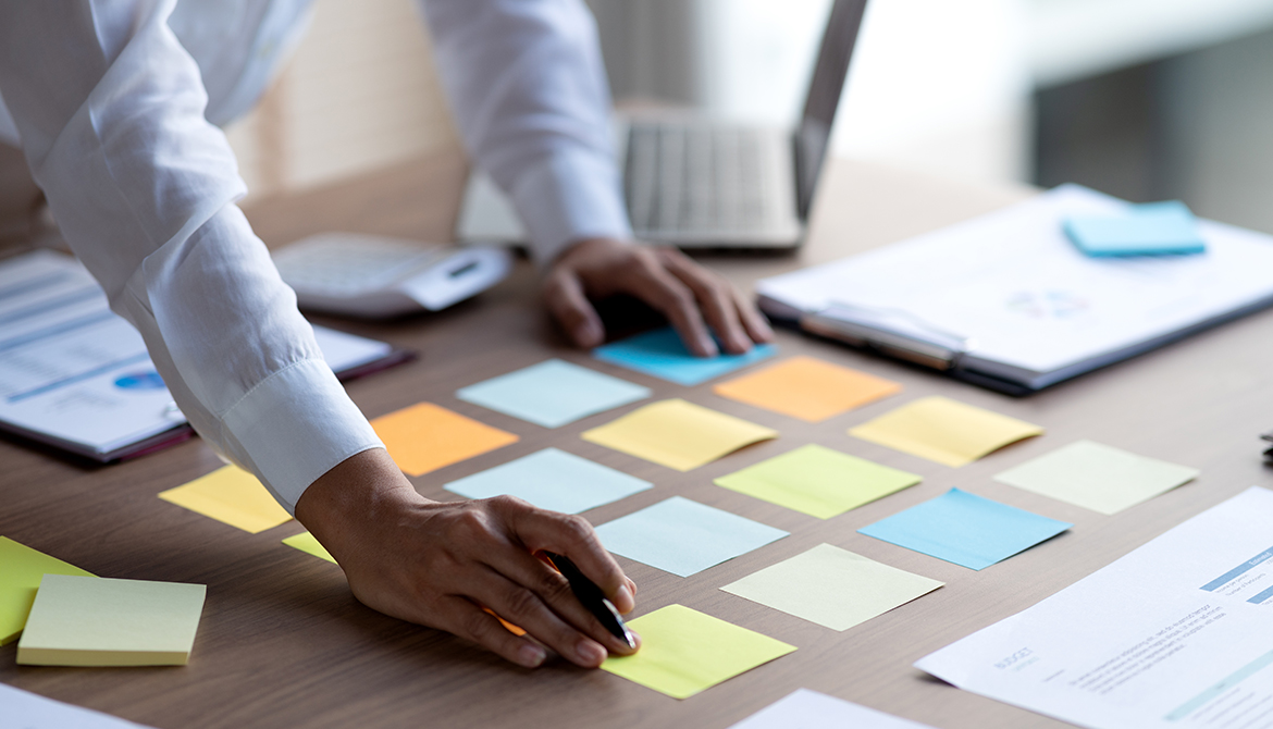 post it notes laid out on desk preparing for meeting