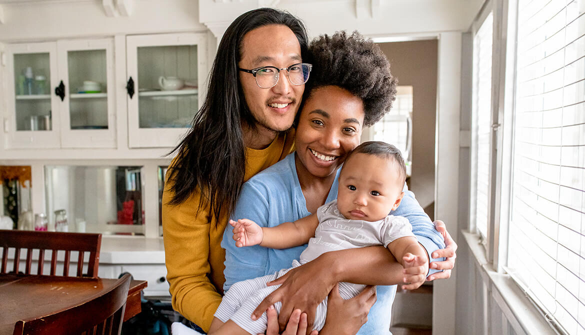 Family of 3 posing in dining room