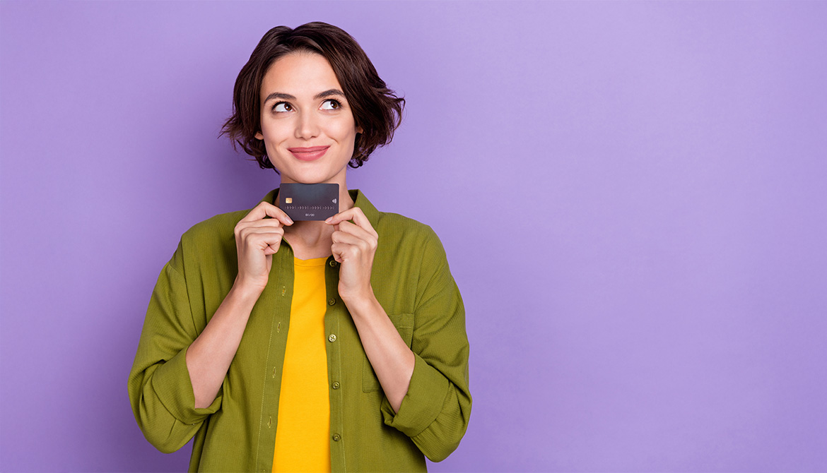 Woman smiling holding credit card