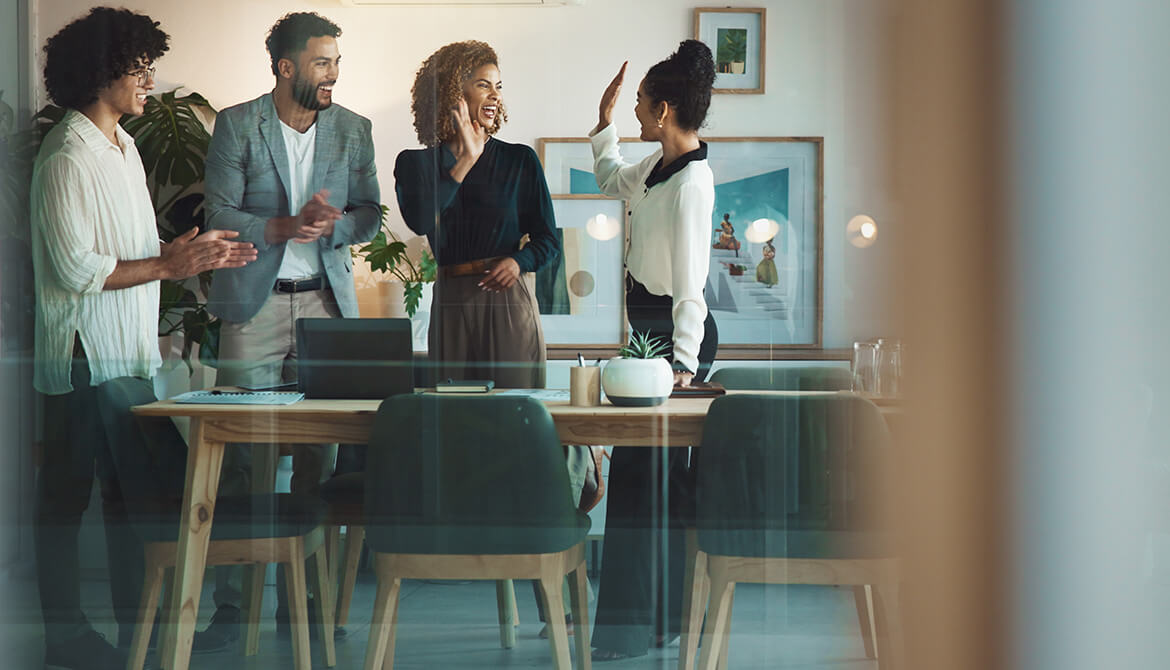 two women hands up for a high-five behind a table