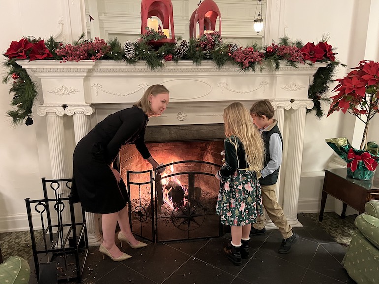 Laurie Maddalena and family releasing last year's bad habits and feelings written on paper into the fireplace