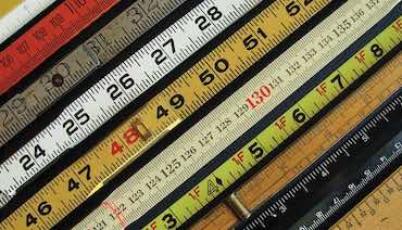 collection of colorful old wooden rulers
