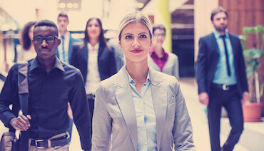 Group of young professionals walking through office