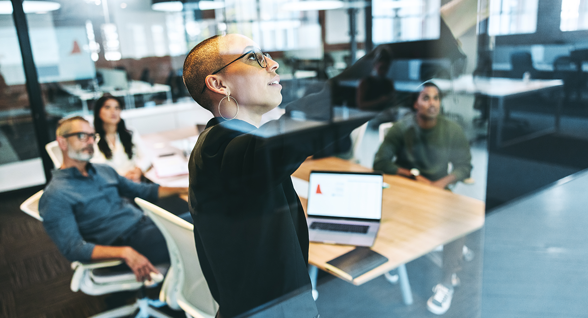 woman pointing at board in meeting