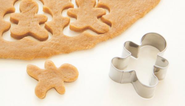 a cookie cutter with gingerbread men cookie shapes