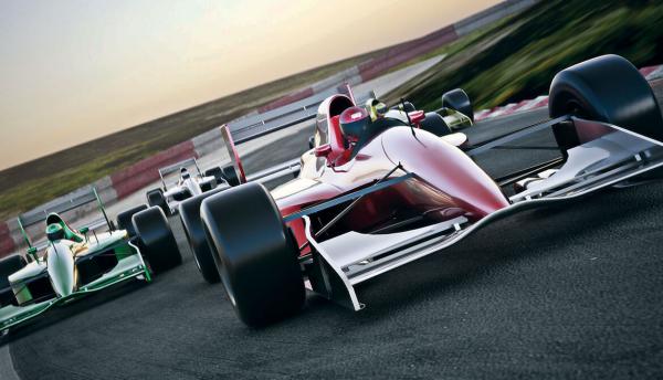 red formula 1 race car speeding along a track