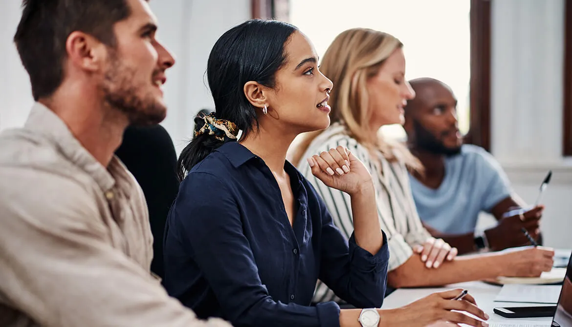 interns eagerly looking ahead at someone speaking