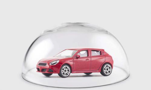 Red car protected under a glass dome