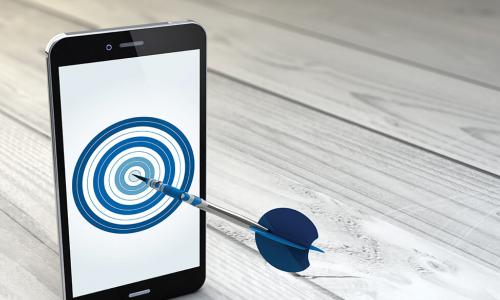 smartphone displaying a bullseye with a dart sticking out of the screen