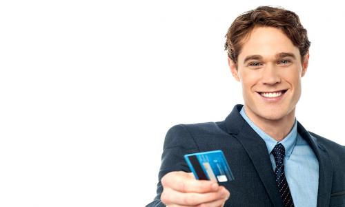 Smiling businessman handing over his debit card