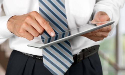 businessman board member using iPad tablet with board portal