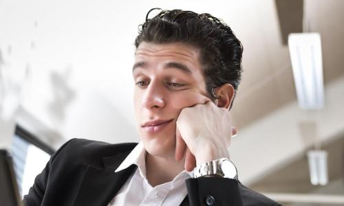 male business employee is bored in front of his computer shows lack of engagement commitment to job