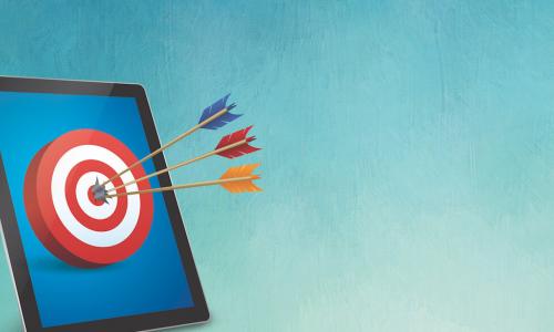 a tablet has a target with arrows in the bullseye
