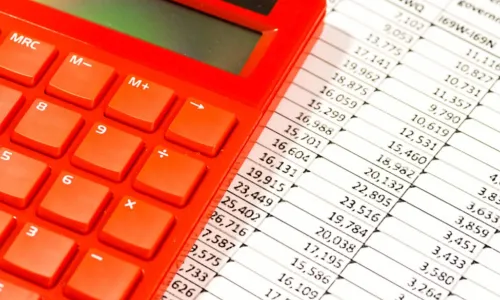 red calculator on top of a spreadsheet