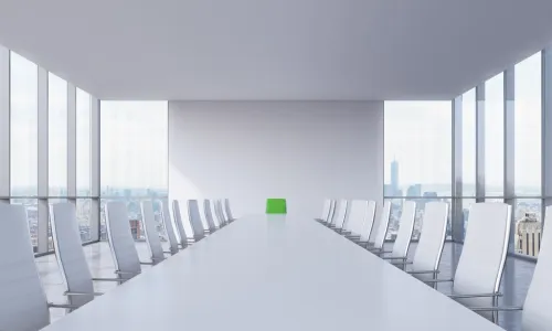 White modern conference room with a green chair in a head of the table