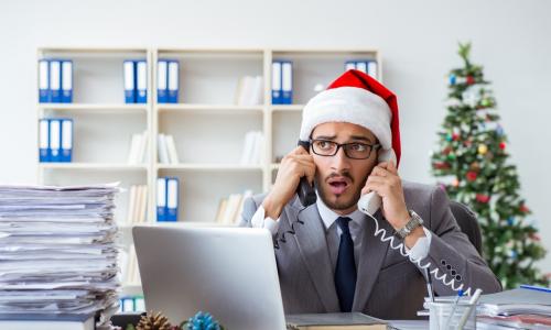 Stressed businessman celebrating Christmas in the office