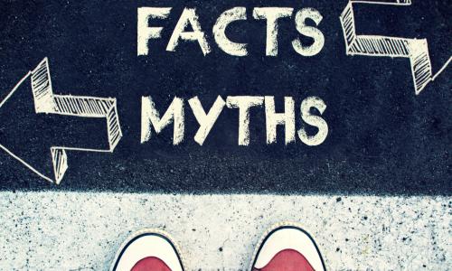 shoes on the pavement that has written on it "facts" and "myths"