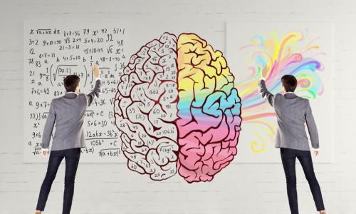 two business people draw and color in an illustration of a brain