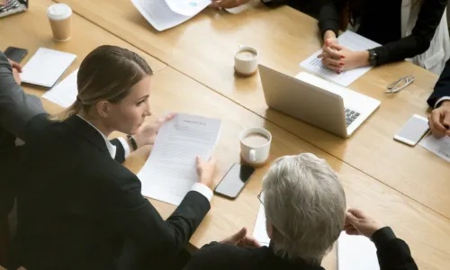 two women at a negotiation table