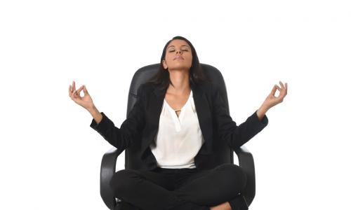 business woman meditating in an executive chair