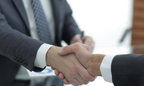 shaking hands with newly hired or promoted executive