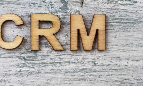 the letters C R M on a wooden table