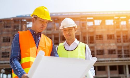 Architect and contractor reviewing plans during a construction project