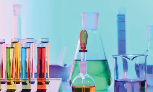 colorful vials of liquid and chemistry equipment