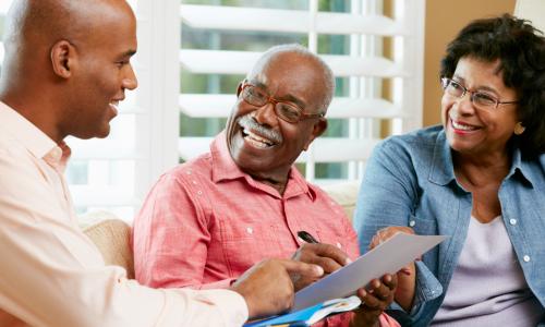 financial advisor talking to senior couple at home