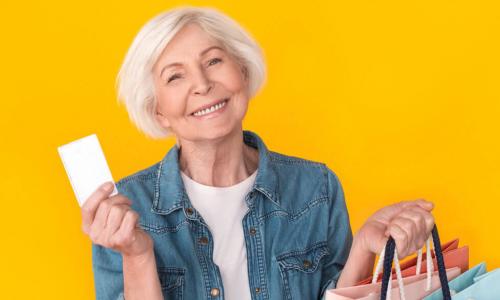 happy senior woman shopping with credit card