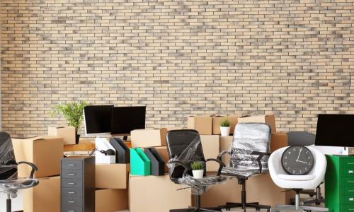 packed boxes and furniture in new office space