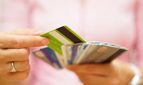 woman in pink choosing one card from a stack