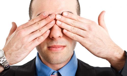 executive covering his eyes with his fingers