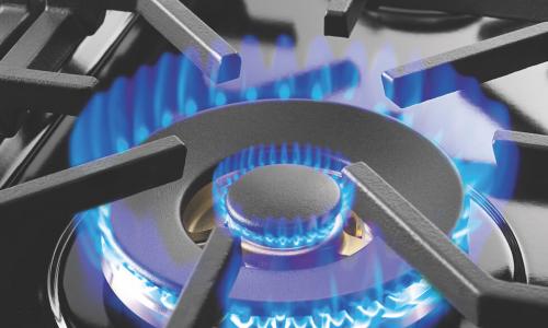 a blue flame on a stovetop burner