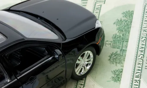 car sits on a 100 dollar bill